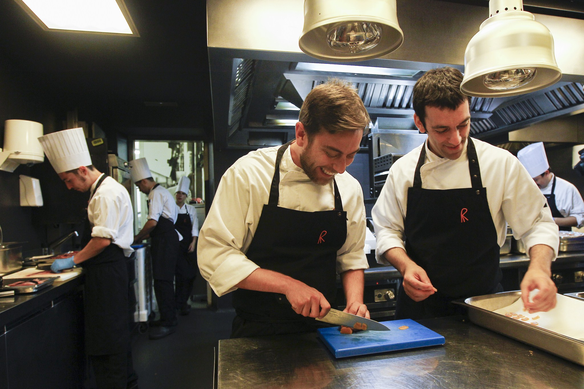 Chefs of the restaurant "El Celler de Can Roca" Spanish Nacho Baucells (L) and Argentinian Hernan Luchetti (R) work in the kitchen in Girona on June 2, 2015. Spain's "El Celler de Can Roca" was crowned the world's best restaurant on June 1, 2015 winning praise for the "collective genius" of the three brothers who run it. It was the second time the Girona eatery has topped the World's 50 Best Restaurant awards in London, after taking the number one spot in 2013.   AFP PHOTO/ QUIQUE GARCIA        (Photo credit should read QUIQUE GARCIA/AFP/Getty Images)