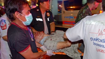 Thai rescue workers transport an injured person after a bomb exploded outside a religious shrine in central Bangkok late on August 17, 2015 killing at least 10 people and wounding scores more. Body parts were scattered across the street after the explosion outside the Erawan Shrine in the downtown Chidlom district of the Thai capital. AFP PHOTO / PORNCHAI KITTIWONGSAKUL (Photo credit should read PORNCHAI KITTIWONGSAKUL/AFP/Getty Images)