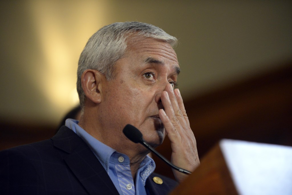 Guatemalan President Otto Perez Molina gestures during a press conference at the presidential residence in Guatemala City on April 17, 2015. Perez Moline informed about the operation carried out by security authorities and members of the International Commission against Impunity in Guatemala (CICIG), that eventually led to the arrest of about 20 people on charges of operating a network of smuggling and tax fraud. AFP PHOTO Johan ORDONEZ (Photo credit should read JOHAN ORDONEZ/AFP/Getty Images)