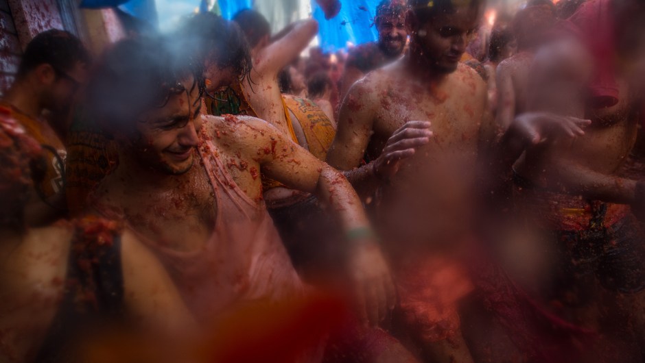 BUNOL, SPAIN - AUGUST 26: Revellers enjoy the atmosphere in tomato pulp while participating the annual Tomatina festival on August 26, 2015 in Bunol, Spain. An estimated 22,000 people threw 150 tons of ripe tomatoes in the world's biggest tomato fight held annually in this Spanish Mediterranean town. (Photo by David Ramos/Getty Images)