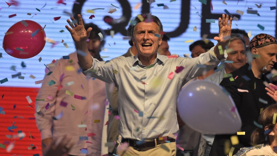 Argentine presidential candidate Mauricio Macri gestures at supporters at the party's headquarters in Buenos Aires on October 25, 2015. Buenos Aires Governor Daniel Scioli led Argentina's presidential election race as counting got under way Sunday, but it was unclear whether he would avoid a runoff against his conservative rival Mauricio Macri. AFP PHOTO / EITAN ABRAMOVICH (Photo credit should read EITAN ABRAMOVICH/AFP/Getty Images)