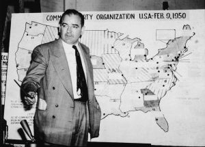 El político estadounidense Joseph McCarthy (1908-1957), senador republicano por Wisconsin, testifica en contra del ejército de Estados Unidos durante el juicio Army-McCarthy, en Washington D.C., el 9 de junio de 1959. McCarthy está frente a un mapa en el que ubica la actividad comunista en los EE.UU.(Crédito: Getty Images)