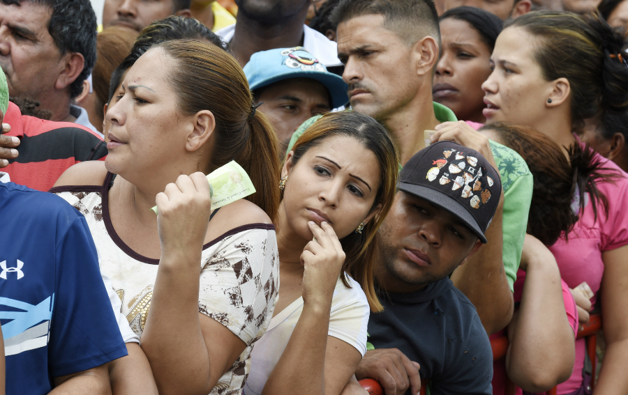 Un grupo de personas hace fila para comprar pollo en Caracas en enero de 2015. 