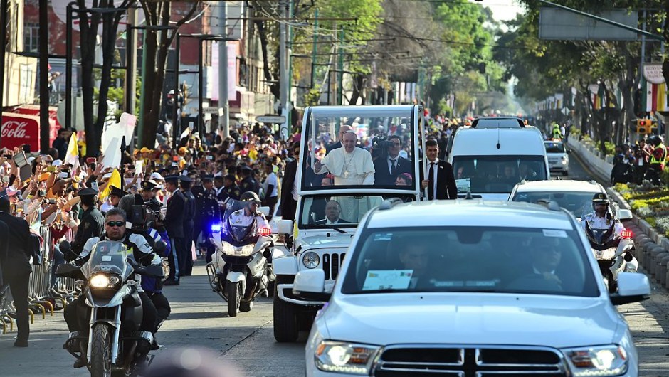 Pope Francis waves at the crowd from the popemobile on his way to the Guadalupe Basilica in Mexico City on February 13, 2016. Pope Francis urged Mexican bishops Saturday to take on drug trafficking with "prophetic courage," warning that it represents a moral challenge to society and the church. AFP PHOTO / RONALDO SCHEMIDT / AFP / RONALDO SCHEMIDT (Photo credit should read RONALDO SCHEMIDT/AFP/Getty Images)