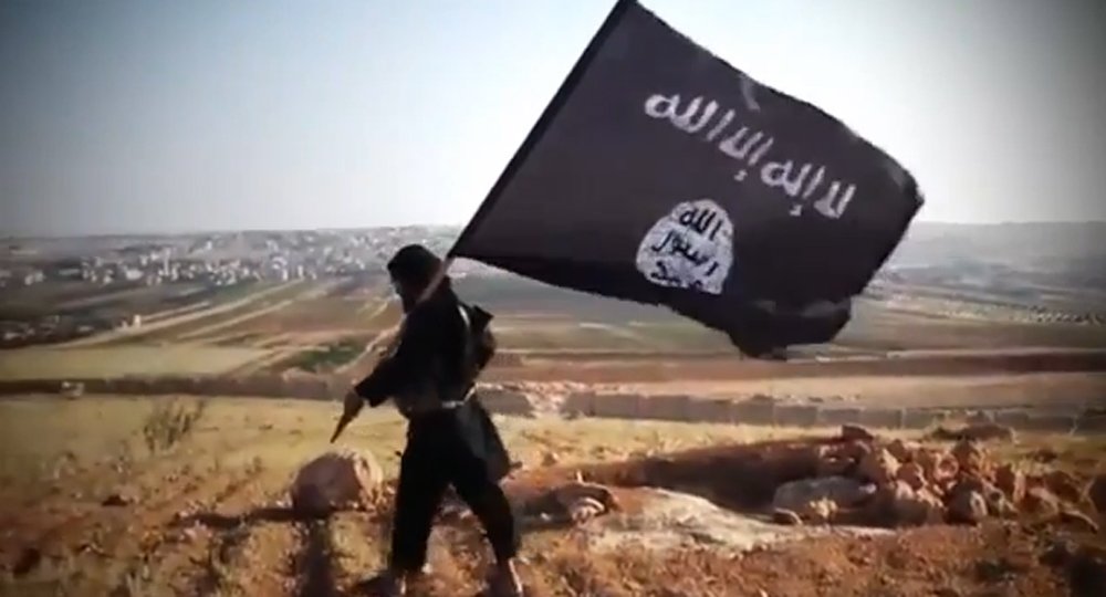An image grab taken from a video uploaded on YouTube on August 23, 2013 allegedly shows a member of Ussud Al-Anbar (Anbar Lions), a Jihadist group affiliated to the Islamic State of Iraq and the Levant , Al-Qaeda's front group in Iraq, holding up the trademark black and white Islamist flag at an undisclosed location in Iraq's Anbar province. Attacks in Iraq killed 14 people including six soldiers on August 25, Iraqi officials said, amid a surge in violence authorities have so far failed to stem despite wide-ranging operations targeting militants. Arabic writing on the flag reads: "There is not God but God and Mohammed is the prophet of God." AFP PHOTO / YOUTUBE == RESTRICTED TO EDITORIAL USE - MANDATORY CREDIT "AFP PHOTO / YOUTUBE " - NO MARKETING NO ADVERTISING CAMPAIGNS - DISTRIBUTED AS A SERVICE TO CLIENTS FROM FROM ALTERNATIVE SOURCES, THEREFORE AFP IS NOT RESPONSIBLE FOR ANY DIGITAL ALTERATIONS TO THE PICTURE'S EDITORIAL CONTENT, DATE AND LOCATION WHICH CANNOT BE INDEPENDENTLY VERIFIED ==