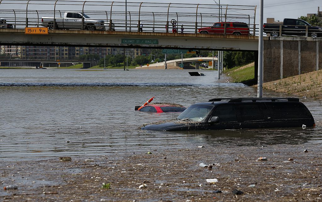 Vehicles are left stranded on Texas State Highway 288 in Houston, Texas on May 26, 2015. Heavy rains throught Texas put the city of Houston under massive amounts of water, closing roadways and trapping residents in their cars and buildings, according to local reports. Rainfall reached up to 11 inches (27.9cm) in some parts of the state, according to national forecasters, and the heavy rains quickly pooled over the state's already saturated soil. AFP PHOTO/AARON M. SPRECHER (Photo credit should read Aaron M. Sprecher/AFP/Getty Images)