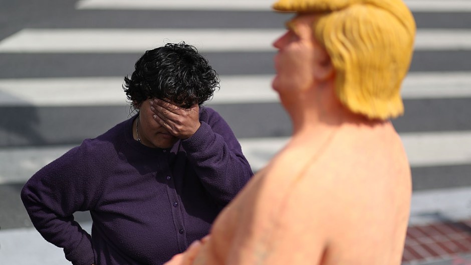 SAN FRANCISCO, CA - AUGUST 18: A passerby looks at a statue depicting republican presidential nominee Donald Trump in the nude on August 18, 2016 in San Francisco, United States. Anarchist collective INDECLINE has created five statues depicting Donald Trump in the nude and placed them in five U.S. cities on Thursday morning. The statues are in San Francisco, New York, Los Angeles, Cleveland and Seattle. (Photo by Justin Sullivan/Getty Images)
