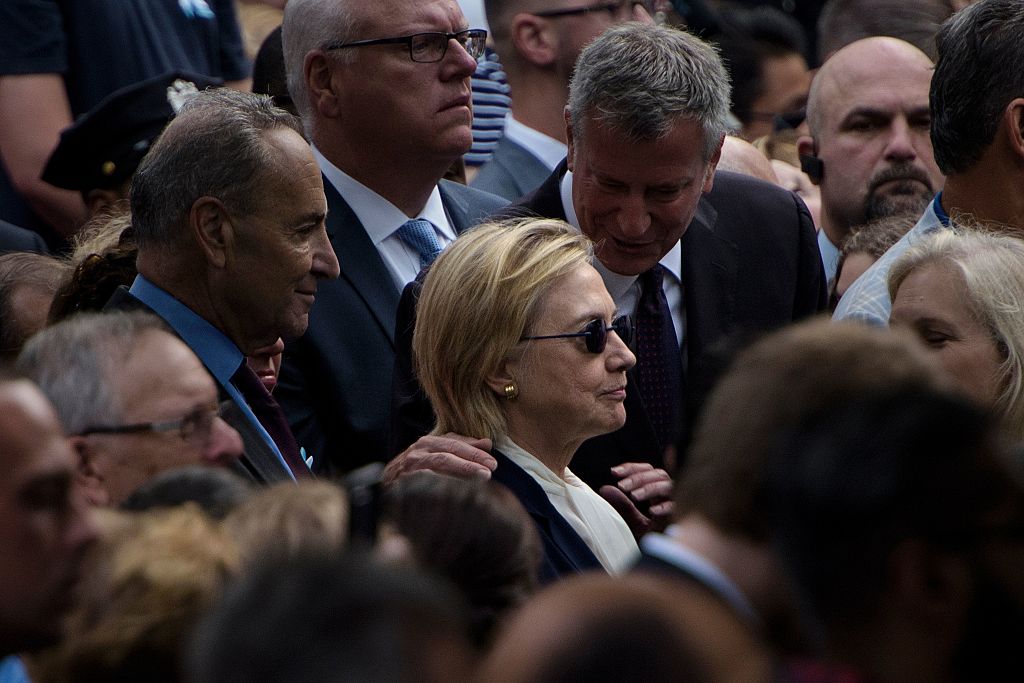 TOPSHOT - New York City Mayor Bill de Blasio speaks to US Democratic presidential nominee Hillary Clinton during a memorial service at the National 9/11 Memorial September 11, 2016 in New York. The United States on Sunday commemorated the 15th anniversary of the 9/11 attacks. / AFP / Brendan Smialowski (Photo credit should read BRENDAN SMIALOWSKI/AFP/Getty Images)