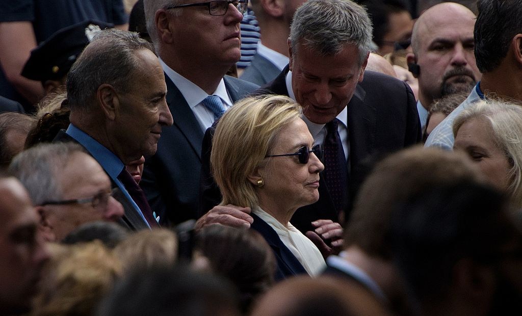 TOPSHOT - New York City Mayor Bill de Blasio speaks to US Democratic presidential nominee Hillary Clinton during a memorial service at the National 9/11 Memorial September 11, 2016 in New York. The United States on Sunday commemorated the 15th anniversary of the 9/11 attacks. / AFP / Brendan Smialowski (Photo credit should read BRENDAN SMIALOWSKI/AFP/Getty Images)