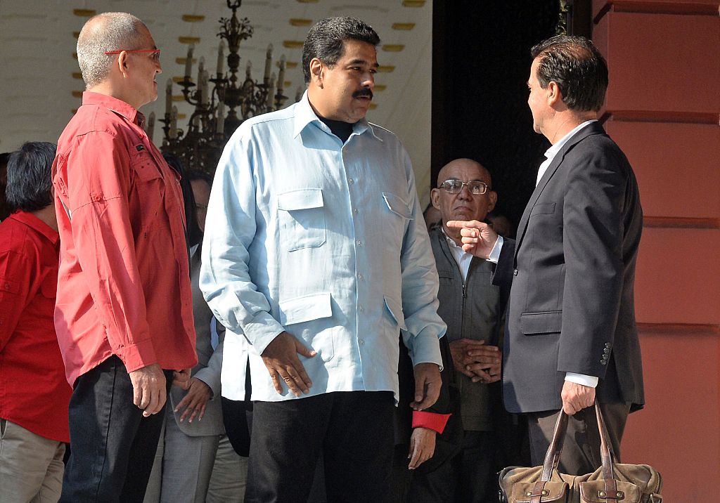 Venezuelan President Nicolas Maduro (C) speaks with the head negotiators of the Colombian government Frank Pearl, next to country's ELN left-wing guerrilla Eliecer Herlinton Chamorro Acosta, aka Antonio Garcia (L) at the end of a meeting at Miraflores presidential palace in Caracas on March 30, 2016. These talks would open a new front in peace negotiations as the government also closes in on a deal with the country's biggest guerrilla group, the Revolutionary Armed Forces of Colombia (FARC). The complex conflict between right- and left-wing guerrillas, government troops and gangs in Colombia is considered the last major armed confrontation in the Western Hemisphere. AFP PHOTO / FEDERICO PARRA / AFP / FEDERICO PARRA (Photo credit should read FEDERICO PARRA/AFP/Getty Images)