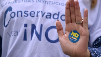 A woman supporting the vote for "No" in the upcoming referendum, takes part in a motorcade in Bogota, on October 1, 2016. Colombians will vote a referendum Sunday on whether to ratify a historic peace accord to end the 52-year war between the state and the communist FARC rebels. The accord will effectively end what is seen as the last major armed conflict in the Western Hemisphere. The war has killed hundreds of thousands of people and displaced millions. / AFP / GUILLERMO LEGARIA (Photo credit should read GUILLERMO LEGARIA/AFP/Getty Images)