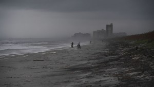 People bike on the beach ahead of hurricane Matthew in Atlantic Beach, Florida, on October 5, 2016. The United States began evacuating coastal areas as Hurricane Matthew churned toward the Bahamas, after killing at least nine people in the Caribbean in a maelstrom of wind, mud and water. / AFP / Jewel SAMAD (Photo credit should read JEWEL SAMAD/AFP/Getty Images)