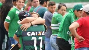 TOPSHOT - People pay tribute to the players of Brazilian team Chapecoense Real who were killed in a plane accident in the Colombian mountains, at the club's Arena Conda stadium in Chapeco, in the southern Brazilian state of Santa Catarina, on November 29, 2016. Players of the Chapecoense were among 81 people on board the doomed flight that crashed into mountains in northwestern Colombia, in which officials said just six people were thought to have survived, including three of the players. Chapecoense had risen from obscurity to make it to the Copa Sudamericana finals scheduled for Wednesday against Atletico Nacional of Colombia. / AFP / Nelson ALMEIDA (Photo credit should read NELSON ALMEIDA/AFP/Getty Images)