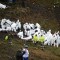 TOPSHOT - EDITORS NOTE: Graphic content / Members of the forensics team recover the bodies of victims of the LAMIA airlines charter plane crash in the mountains of Cerro Gordo, municipality of La Union, on November 29, 2016. A charter plane carrying the Chapecoense Real football team crashed in the mountains in Colombia late Monday, killing as many as 75 people, officials said. / AFP / RAUL ARBOLEDA (Photo credit should read RAUL ARBOLEDA/AFP/Getty Images)