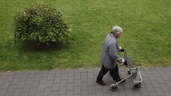 BERLIN, GERMANY - AUGUST 30: An elderly woman pushes a walker along a path in the gardens of the Sewanstrasse senior care home in Lichtenberg district on August 30, 2011 in Berlin, Germany. The center is participating in Senior Citizens' Week (Berliner Seniorenwoche), a city initiative meant to highlight activities available for the city's eldery. Germany is facing significant demographic change that includes elderly citizens making up an increasing portion of the overall population, a situation aggravated by the country's birth rate, which is the lowest in Europe. The shift will continue to put greater strain on the country's ability to finance its public health and senior care programs. (Photo by Sean Gallup/Getty Images)