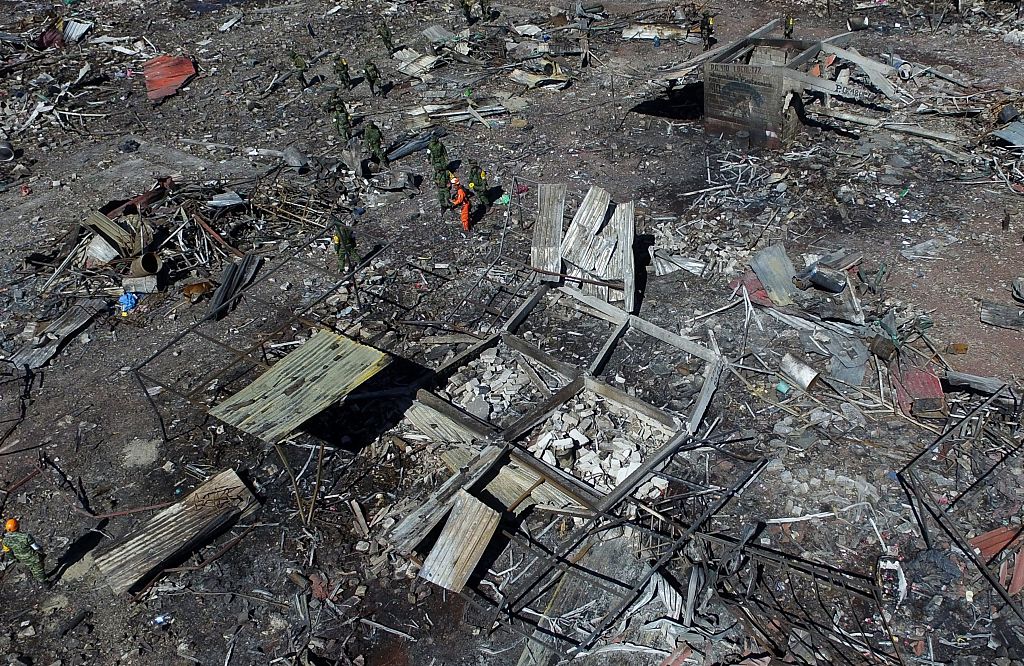 Aerial view of Mexico's biggest fireworks market in Tultepec suburb, Mexico State, after a massive explosion on the eve killed at least 32 people, on December 21, 2016. Mexico worked Wednesday to identify charred bodies left by an explosion at its biggest fireworks market, as authorities investigated what caused the multi-colored salvo of destruction. Forensic experts are carrying out genetic analyses to identify the badly burned remains from Tuesday's blast, with just 13 victims identified so far, said state prosecutor Alejandro Gomez. / AFP / Mario VAZQUEZ (Photo credit should read MARIO VAZQUEZ/AFP/Getty Images)