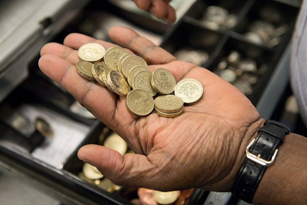 A worker sorts pound coins taken from a cash register in a convenience store in London on October 7, 2016. The Bank of England is "looking into" what caused the pound to slump more than six percent against the dollar in less than ten minutes Friday, a spokesman told AFP. / AFP / JUSTIN TALLIS (Photo credit should read JUSTIN TALLIS/AFP/Getty Images)