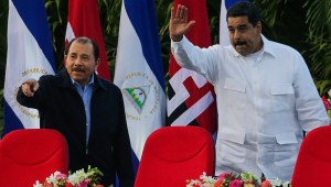 Nicaraguan President Daniel Ortega (L) and Venezuelan President Nicolas Maduro (R) greet supporters during the inauguration ceremony for his fourth term in office in Managua on January 10, 2017. / AFP / INTI OCON (Photo credit should read INTI OCON/AFP/Getty Images)