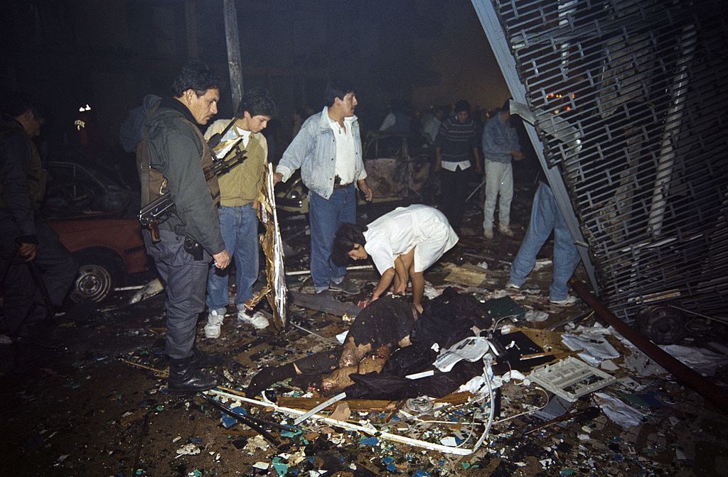 A woman examines the remains of a victim killed late July 16, 1992 in a car bomb attack in the Miraflores residential neighborhood, in Lima. At least 15 people were killed and as many as 250 injured in the attack, which police say was the respopnsibility of the Shining Path guerillas. AFP PHOTO HERTOR MATA (Photo credit should read HECTOR MATA/AFP/Getty Images)
