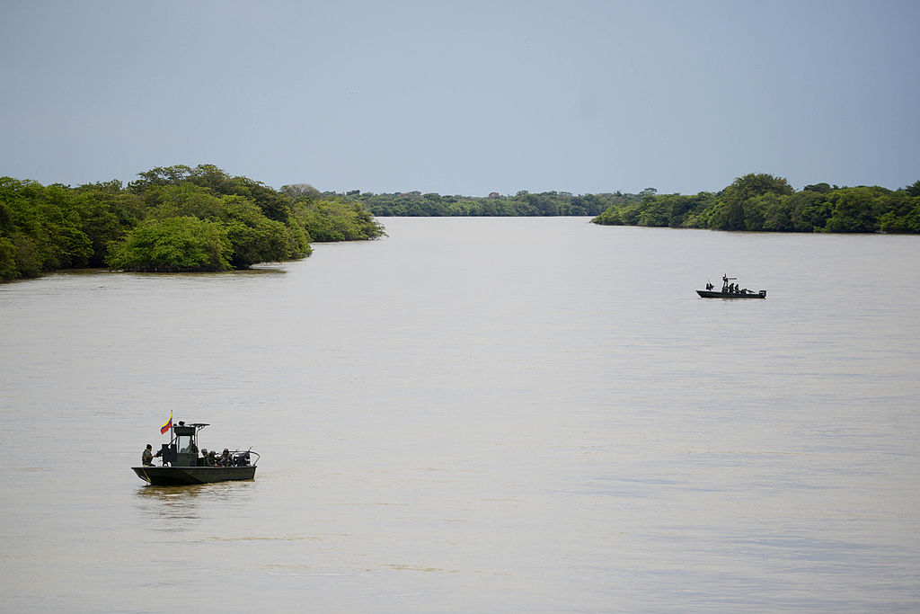 enezuelan Marine Corps patrol the bordering Arauca river, in the Venezuelan state of Apure on August 9, 2013 after Venezuela and Colombia signed border agreements. AFP PHOTO / Leo RAMIREZ (Photo credit should read LEO RAMIREZ/AFP/Getty Images)