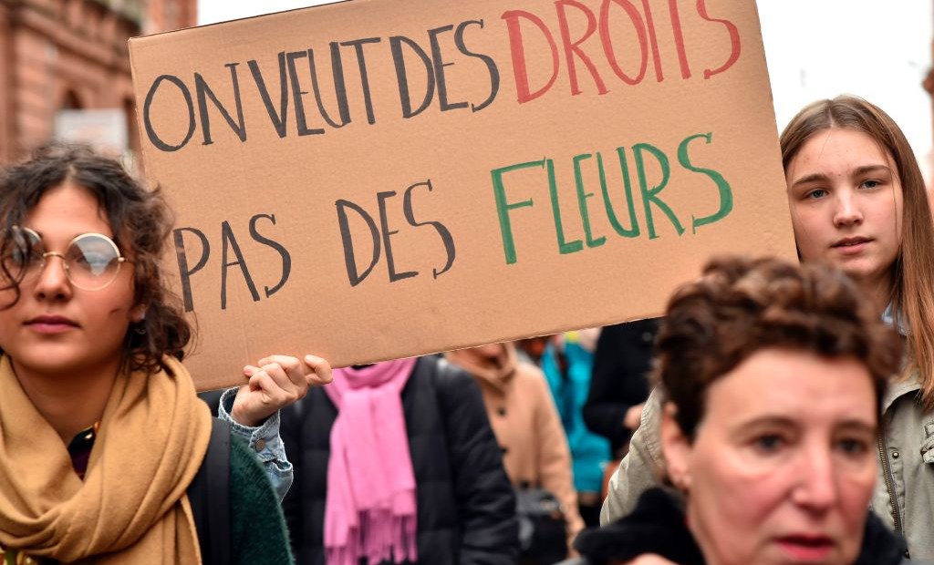 A woman carries a sign reading "We want rights, not flowers" during a demonstration march on March 8, 2017 in Toulouse, as part of International Women's Day. / AFP PHOTO / REMY GABALDA (Photo credit should read REMY GABALDA/AFP/Getty Images)