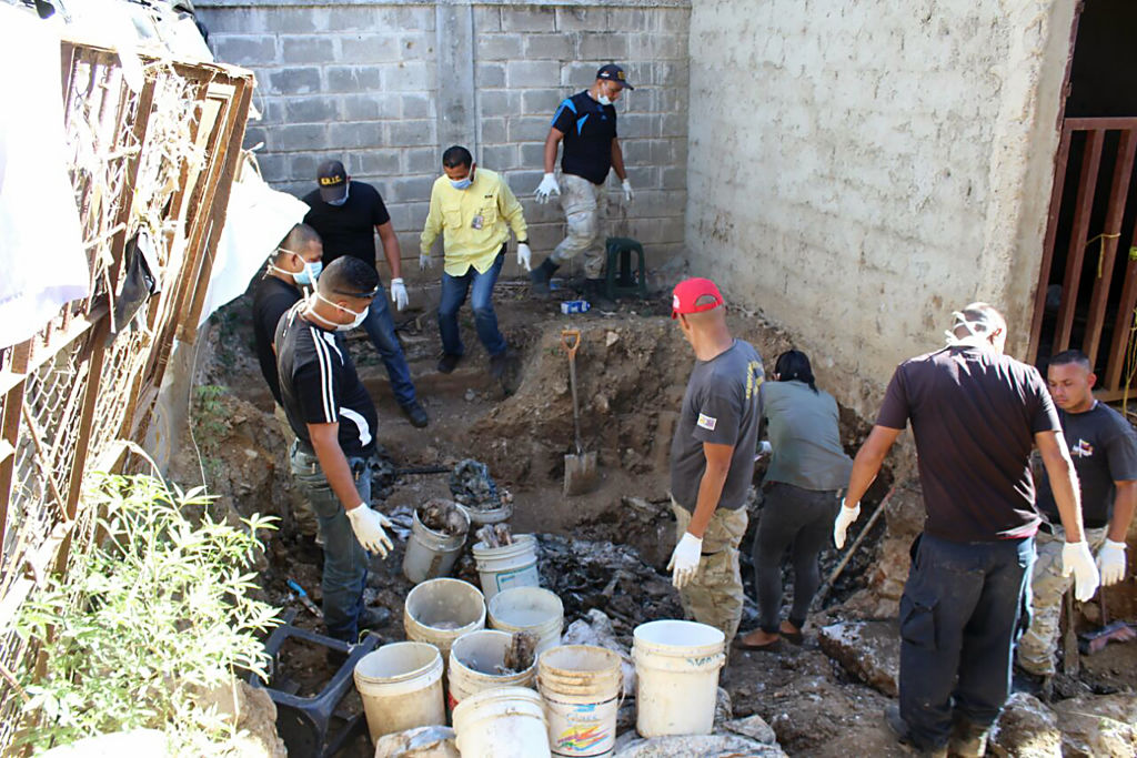 Forensic personnel study the remains of bodies discovered in the General Penitentiary of Venezuela, which had been closed down, in San Juan de los Morros, Guarico state, on March 10, 2017. On October 28, 2016 the government finished transferring the inmates of the General Penitentiary of Venezuela (PGV), a maximum-security prison in San Juan de Los Morros in the central state of Guarico, to a new facility after weeks of fighting between inmates for control of the prison and protests about the death of prisoners due to shortages of food and medicines. / AFP PHOTO / Juan BARRETO (Photo credit should read JUAN BARRETO/AFP/Getty Images)