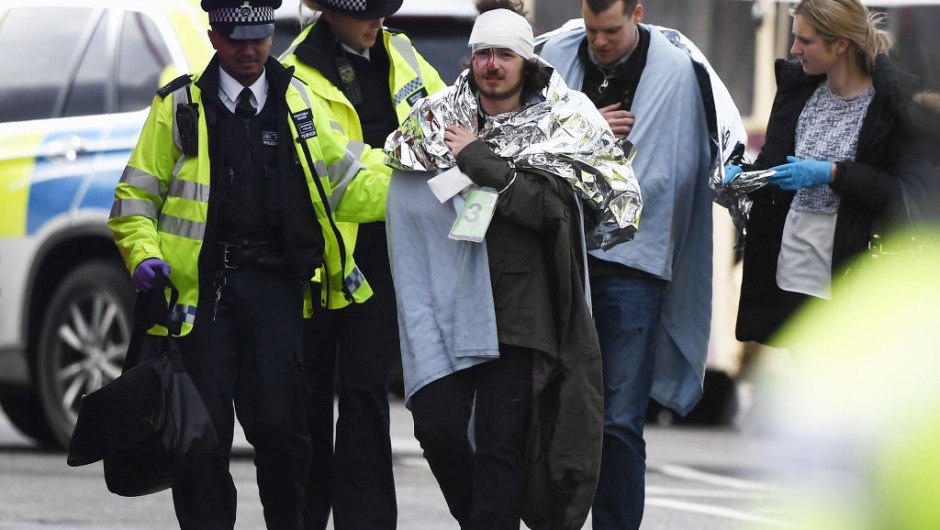 ONDON, ENGLAND - MARCH 22: A member of the public is treated by emergency services near Westminster Bridge and the Houses of Parliament on March 22, 2017 in London, England. A police officer has been stabbed near to the British Parliament and the alleged assailant shot by armed police. Scotland Yard report they have been called to an incident on Westminster Bridge where several people have been injured by a car. (Photo by Carl Court/Getty Images)