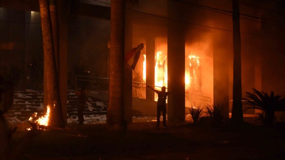 Hundreds of demonstrators protesting against the approval of a constitutional amendment for presidential reelection broke into the Congress building, battering down entrances and fences and shattering windows, and started to set fires inside, in Asuncion on March 31, 2017. Paraguayan senators on Friday approved a contested law allowing President Horacio Cartes to seek reelection in 2018, prompting furious protesters to break into the legislature, ransacking lawmakers' offices and starting fires. / AFP PHOTO / NORBERTO DUARTE (Photo credit should read NORBERTO DUARTE/AFP/Getty Images)
