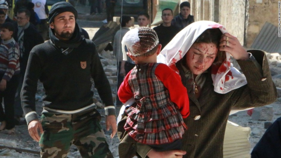 A Syrian women with blood on her face carries a child following a reported air strike by government forces on March 15, 2014 on the northern city of Aleppo. In Aleppo, once Syria's commercial capital, the regime has retained the city's west, while advancing around the outskirts of the rebel-held east and securing and reopening the nearby airport. AFP PHOTO / MOHAMMED AL-TAYBMOHAMAD AL-TAYB/AFP/Getty Images