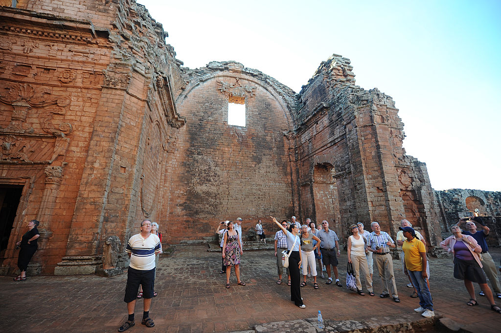 Tourists visit the Jesuitical ruins in Trinidad, Paraguay, on January 27, 2013. The finding of hexagonal tiles from the floor of a large Jesuitical temple built by Guarani indians in the XVII century, rekindled an ambicious project of rediscovering the ruins of the paradise lost when the Jesuits were expelled from the country in 1767. AFP PHOTO/NORBERTO DUARTE (Photo credit should read NORBERTO DUARTE/AFP/Getty Images)