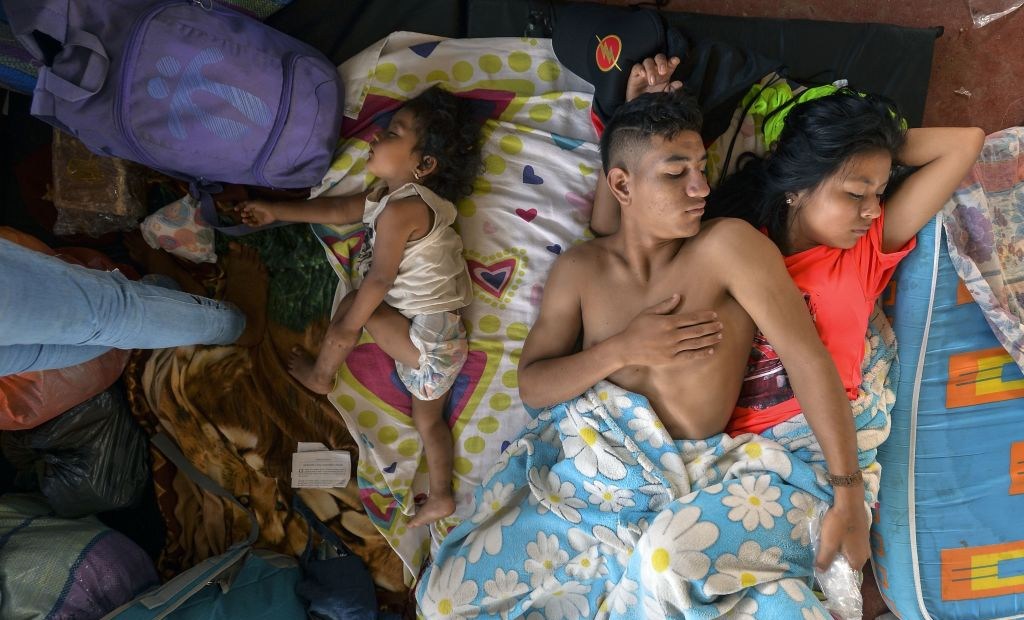 TOPSHOT - A family rests at a shelter in Mocoa, Putumayo department, southern Colombia on April 3, 2017. Residents of Mocoa were Monday desperately searching for loved ones missing since devastating mudslides slammed into the remote Colombian town, as the death toll soared to over 250, including 43 children. / AFP PHOTO / LUIS ROBAYO (Photo credit should read LUIS ROBAYO/AFP/Getty Images)