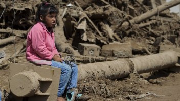 A girl sits amid the debris left by mudslides caused by heavy rains in Mocoa, Putumayo department, southern Colombia on April 4, 2017. The Colombian government on Monday declared a state of economic emergency in the town of Mocoa in southern Colombia, after mudslides left more than 270 people dead, including 43 children. / AFP PHOTO / LUIS ROBAYO (Photo credit should read LUIS ROBAYO/AFP/Getty Images)