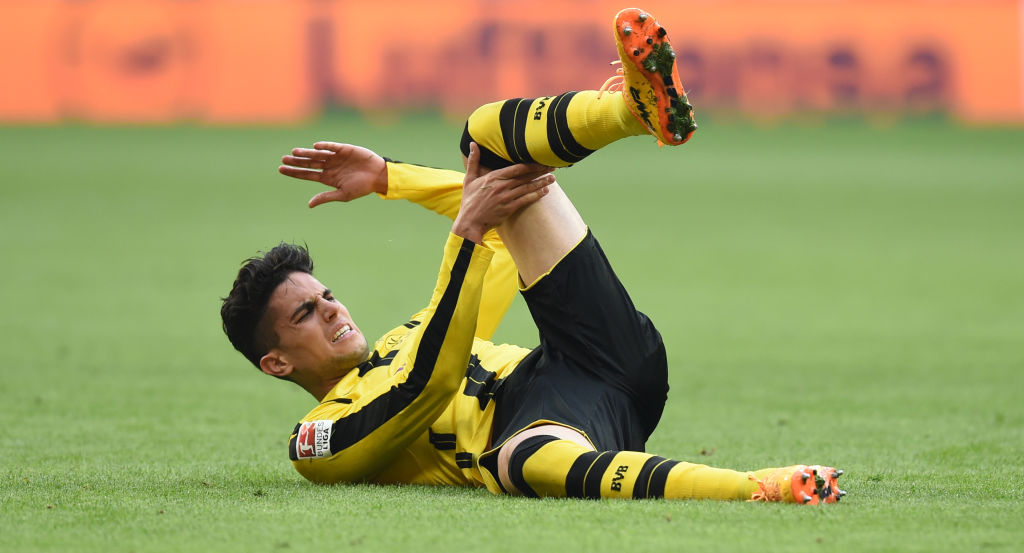 Dortmund's Spanish defender Marc Bartra lays on the pitch during the German first division Bundesliga football match FC Bayern Munich v BVB Borussia Dortmund in Munich, southern Germany, on April 8, 2017. / AFP PHOTO / Christof STACHE / RESTRICTIONS: DURING MATCH TIME: DFL RULES TO LIMIT THE ONLINE USAGE TO 15 PICTURES PER MATCH AND FORBID IMAGE SEQUENCES TO SIMULATE VIDEO. == RESTRICTED TO EDITORIAL USE == FOR FURTHER QUERIES PLEASE CONTACT DFL DIRECTLY AT + 49 69 650050 (Photo credit should read CHRISTOF STACHE/AFP/Getty Images)