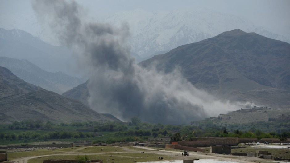 In this photograph taken on April 11, 2017, smoke rises after an air strike by US aircraft on positions during an ongoing an operation against Islamic State (IS) militants in the Achin district of Afghanistan's Nangarhar province. An American special forces soldier has been killed while conducting operations against the Islamic State group in Afghanistan, the US military said. The US-backed Afghan military has vowed to wipe out the group in its strongholds in the eastern province of Nangarhar as IS challenges the more powerful Taliban on its own turf. / AFP PHOTO / NOORULLAH SHIRZADA (Photo credit should read NOORULLAH SHIRZADA/AFP/Getty Images)