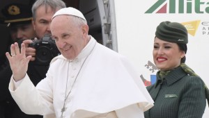 Pope Francis waves to the press as he is welcomed by Alitalia's personnel prior his flight to Egypt, on April 28, 2017 at Rome's Fiumicino airport. Pope Francis heads for a two-day visit in Egypt for talks with the grand imam of the capital's famed Al-Azhar mosque in Cairo, but also to show solidarity with Coptic Christians targeted by violence in Egypt. / AFP PHOTO / Tiziana FABI (Photo credit should read TIZIANA FABI/AFP/Getty Images)