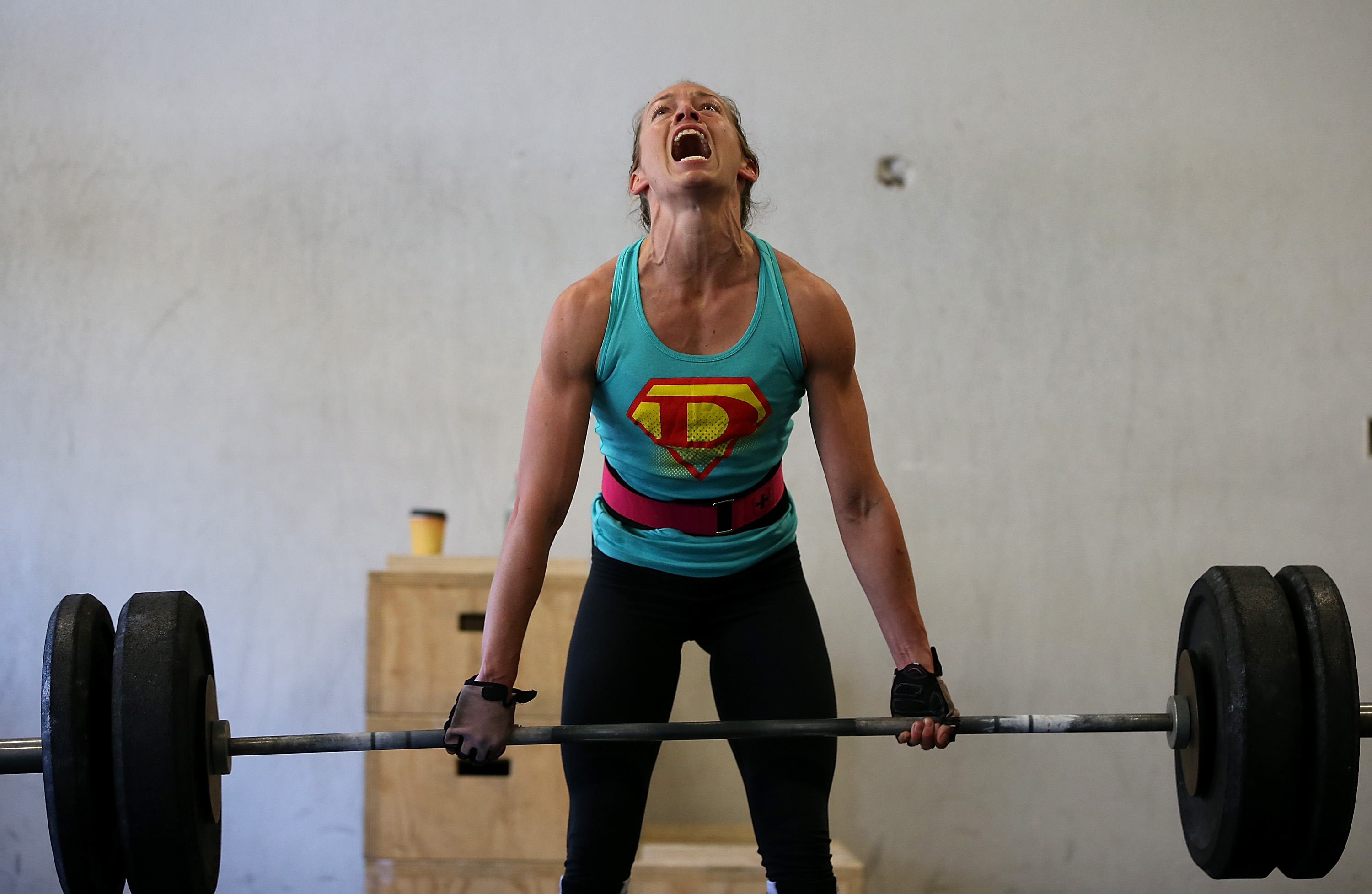 SAN ANSELMO, CA - MARCH 14: Lita Collins does a deadlift during a CrossFit workout at Ross Valley CrossFit on March 14, 2014 in San Anselmo, California. CrossFit, a high intensity workout regimen that is a constantly varied mix of aerobic exercise, gymnastics and Olympic weight lifting, is one of the fastest growing fitness programs in the world. The grueling cult-like core strength and conditioning program is popular with firefighters, police officers, members of the military and professional athletes. Since its inception in 2000, the number of CrossFit affiliates, or "boxes" has skyrocketed to over 8,500 worldwide with more opening every year. (Photo by Justin Sullivan/Getty Images)