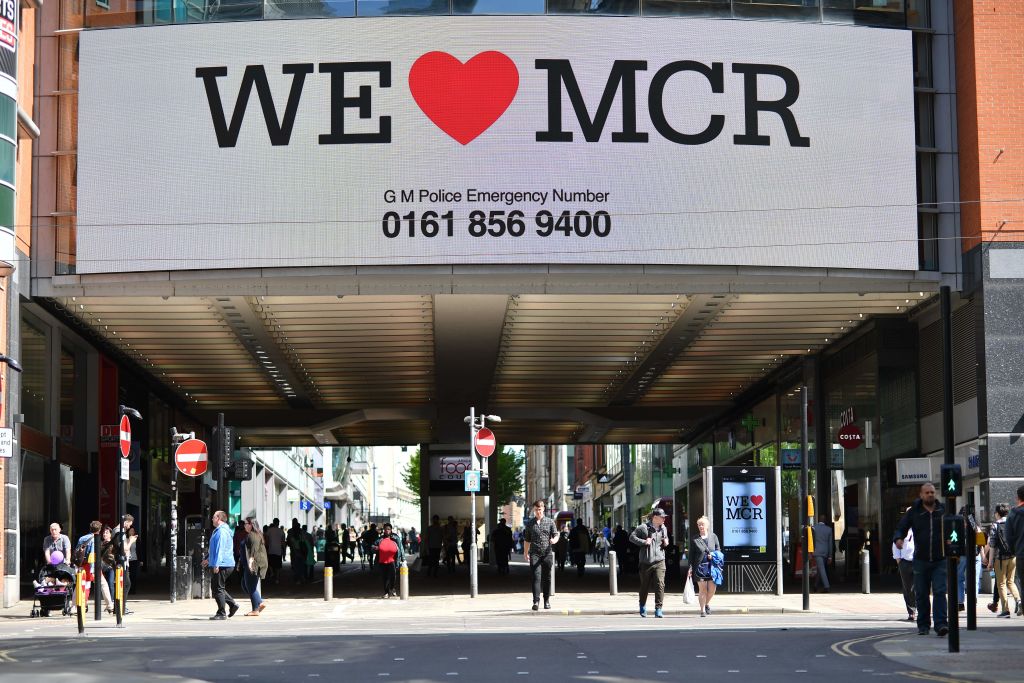 A sign that reads "We Love MCR" is displayed in solidarity above a street in central Manchester, northwest England on May 23, 2017 following a deadly terror attack at a concert at the Manchester Arena the night before. Twenty two people have been killed and dozens injured in Britain's deadliest terror attack in over a decade after a suspected suicide bomber targeted fans leaving a concert of US singer Ariana Grande in Manchester. / AFP PHOTO / Ben STANSALL (Photo credit should read BEN STANSALL/AFP/Getty Images)