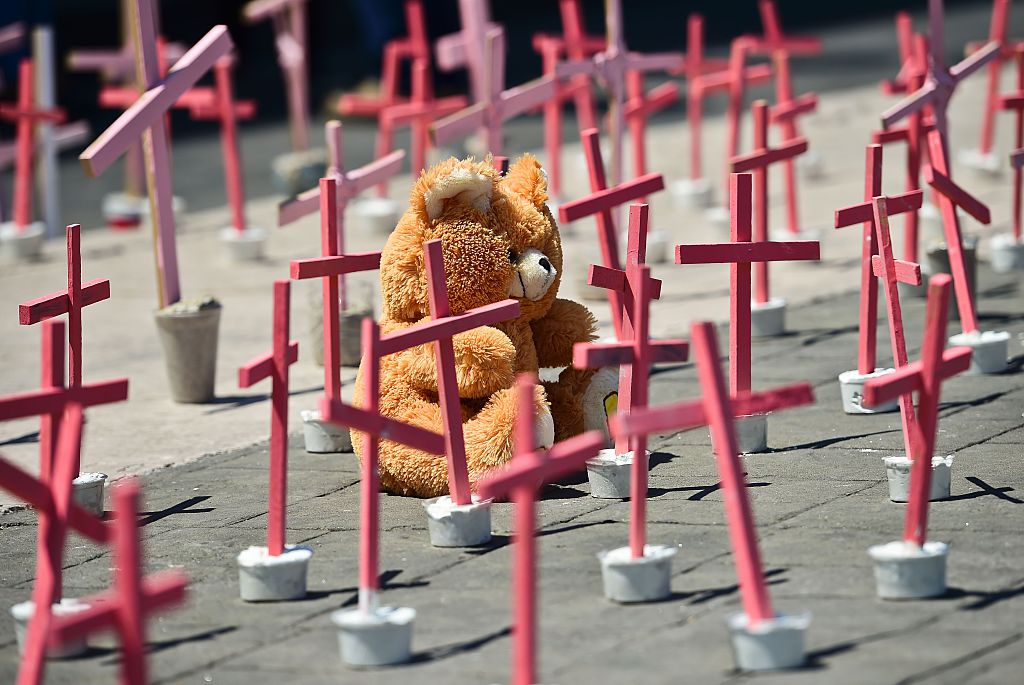 A wooly bear from a victim of femicide are pictured next to crosses during a protest against the murder of more than 600 women in the last four years,  in Ecatepec, State of Mexico, on March 13 , 2016. AFP PHOTO/RONALDO SCHEMIDT / AFP / RONALDO SCHEMIDT        (Photo credit should read RONALDO SCHEMIDT/AFP/Getty Images)