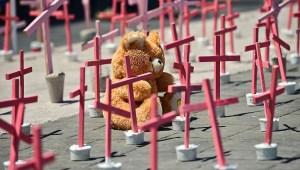 A wooly bear from a victim of femicide are pictured next to crosses during a protest against the murder of more than 600 women in the last four years, in Ecatepec, State of Mexico, on March 13 , 2016. AFP PHOTO/RONALDO SCHEMIDT / AFP / RONALDO SCHEMIDT (Photo credit should read RONALDO SCHEMIDT/AFP/Getty Images)