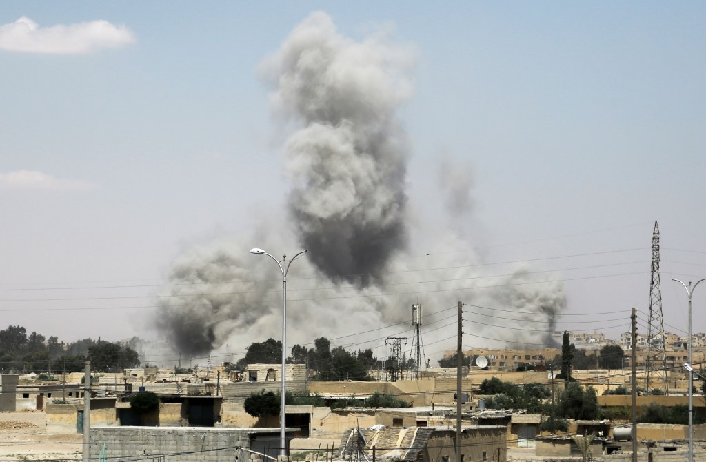 Humo sobre los edificios de la ciudad de Raqa, en el norte de Siria, durante la ofensiva de los combatientes apoyados por Estados Unidos para retomar el bastión del Estado Islámico el 18 de junio de 2017. Crédito: DELIL SOULEIMAN / AFP / Getty Images.