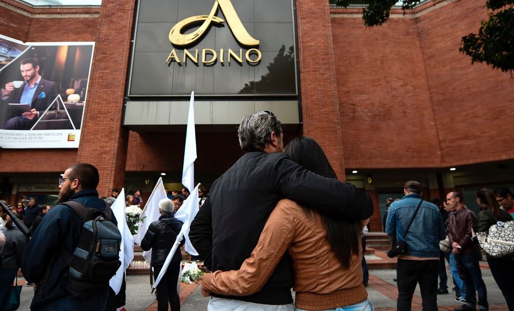 People attend a tribute for the victims a day after three women were killed in a bomb attack at the Andino mall, in Bogota, on June 18, 2017. Colombia's leaders and main rebel groups pledged Sunday that a mall bombing would not disrupt the country's peace process, even as authorities scrambled to find out who was behind the carnage. The victims -- two Colombians and a Frenchwoman -- perished when a device exploded in a ladies' restroom in the crowded Andino shopping centre in Bogota on Saturday. At least nine people were also wounded, officials said. / AFP PHOTO / Raul ARBOLEDA (Photo credit should read RAUL ARBOLEDA/AFP/Getty Images)