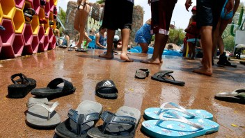 PHOENIX, AZ - JUNE 20: Flip flop sandals are left behind as visitors make their way into the water for relief from the heat at the Wet-N-Wild Water Park on June 20, 2017 in Phoenix, Arizona. Record temperatures of 118 to 120 degrees were expected on Tuesday for the Phoenix-metro area. (Photo by Ralph Freso/Getty Images)