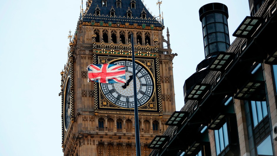 A Union flag flies at half-mast from the roof of a building, in front of a face of the Great Clock of the Palace of Westminster's Elizabeth Tower, more commonly referred to as Big Ben, in London on August 18, 2017, following the August 17 attacks in Barcelona and Cambrils in Spain. Spanish police on Friday hunted for the driver who rammed a van into pedestrians on an avenue crowded with tourists in Barcelona, leaving 13 people dead and more than 100 injured, just hours before a second assault in a resort along the coast. / AFP PHOTO / Tolga AKMEN (Photo credit should read TOLGA AKMEN/AFP/Getty Images)