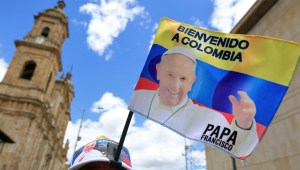A vendor sells flags with the image of Pope Francis in downtown Bogota on September 4, 2017 ahead of the pontiff's visit to Colombia. Pope Francis will make a special four-day visit to Colombia, from September 6-11, to add his weight to the process of reconciliation between the government and the FARC. / AFP PHOTO / John Vizcaino (Photo credit should read JOHN VIZCAINO/AFP/Getty Images)