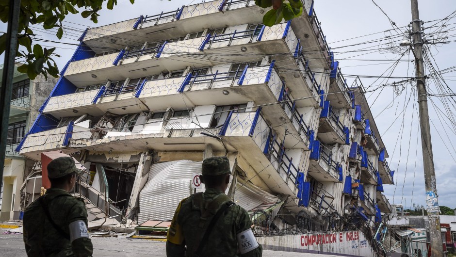 Soldiers stand guard a few metres away from the Sensacion hotel which collapsed with the powerful earthquake that struck Mexico overnight, in Matias Romero, Oaxaca State, on September 8, 2017. Mexico's most powerful earthquake in a century killed at least 35 people, officials said Friday, after it struck the Pacific coast, wrecking homes and sending families fleeing into the streets. / AFP PHOTO / VICTORIA RAZO (Photo credit should read VICTORIA RAZO/AFP/Getty Images)