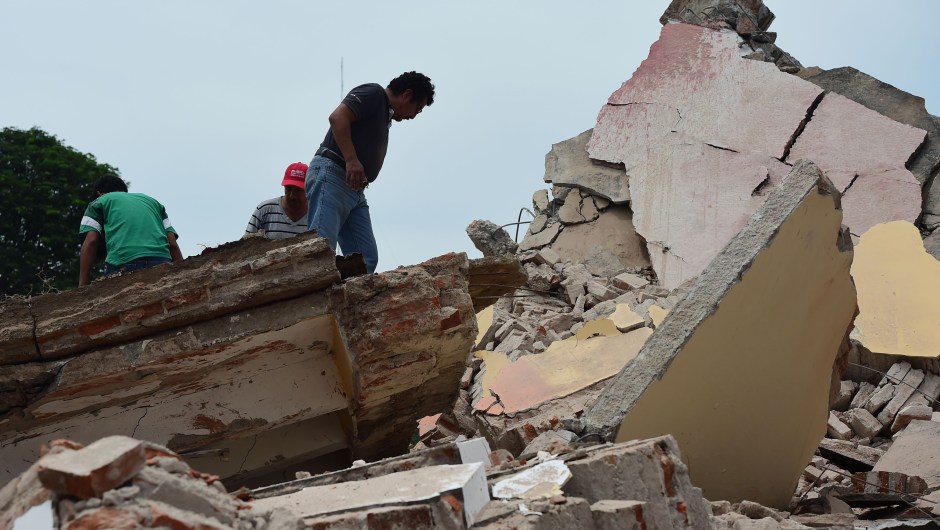 Local police members and volunteers remove rubble after the Town Hall building partially collapsed following an 8.2 earthquake that hit Mexico's Pacific coast, in Juchitan de Zaragoza, state of Oaxaca on September 8, 2017. Mexico's most powerful earthquake in a century killed at least 35 people, officials said, after it struck the Pacific coast, wrecking homes and sending families fleeing into the streets. / AFP PHOTO / RONALDO SCHEMIDT (Photo credit should read RONALDO SCHEMIDT/AFP/Getty Images)