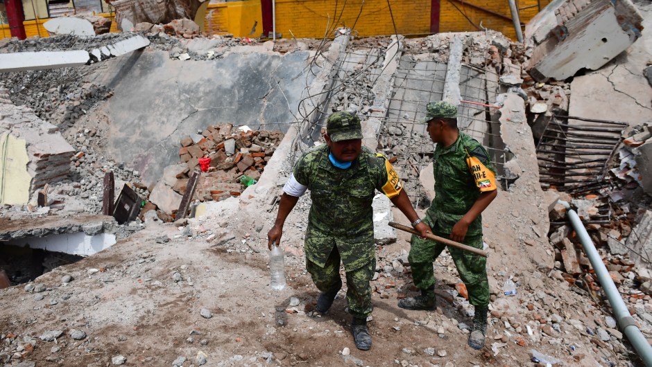 Mexican soldiers walk amid debris of the Town Hall building which partially collapsed following an 8.2 magnitude earthquake that hit Mexico's Pacific coast, in Juchitan de Zaragoza, state of Oaxaca on September 8, 2017. Mexico's most powerful earthquake in a century killed at least 35 people, officials said, after it struck the Pacific coast, wrecking homes and sending families fleeing into the streets. / AFP PHOTO / RONALDO SCHEMIDT (Photo credit should read RONALDO SCHEMIDT/AFP/Getty Images)