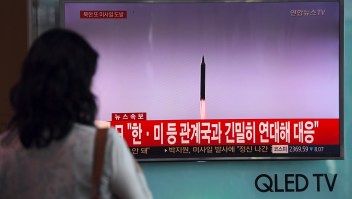 A woman watches a screen showing file footage of a North Korean missile launch, at a railway station in Seoul on September 15, 2017. North Korea fired an intermediate range ballistic missile eastwards over Japan and into the Pacific on September 15, the US said, its latest provocation amid high tensions over its banned weapons programmes. / AFP PHOTO / JUNG Yeon-Je (Photo credit should read JUNG YEON-JE/AFP/Getty Images)