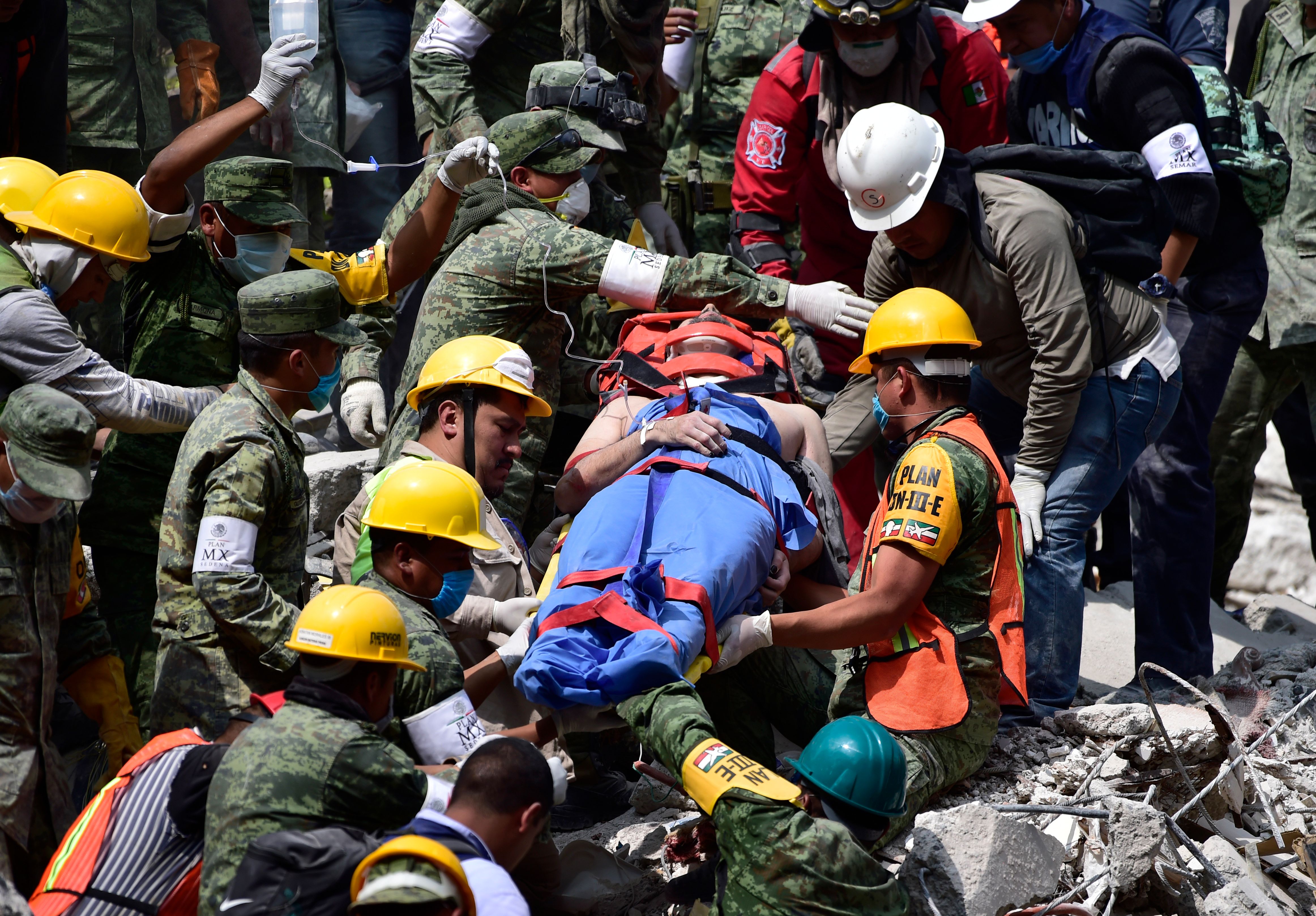 A survivor is pulled out of the rubble from a flattened building in Mexico City on September 20, 2017 as the search for survivors continues a day after a strong quake hit central Mexico. A powerful 7.1 earthquake shook Mexico City on Tuesday, causing panic among the megalopolis' 20 million inhabitants on the 32nd anniversary of a devastating 1985 quake. / AFP PHOTO / Pedro PARDO (Photo credit should read PEDRO PARDO/AFP/Getty Images)