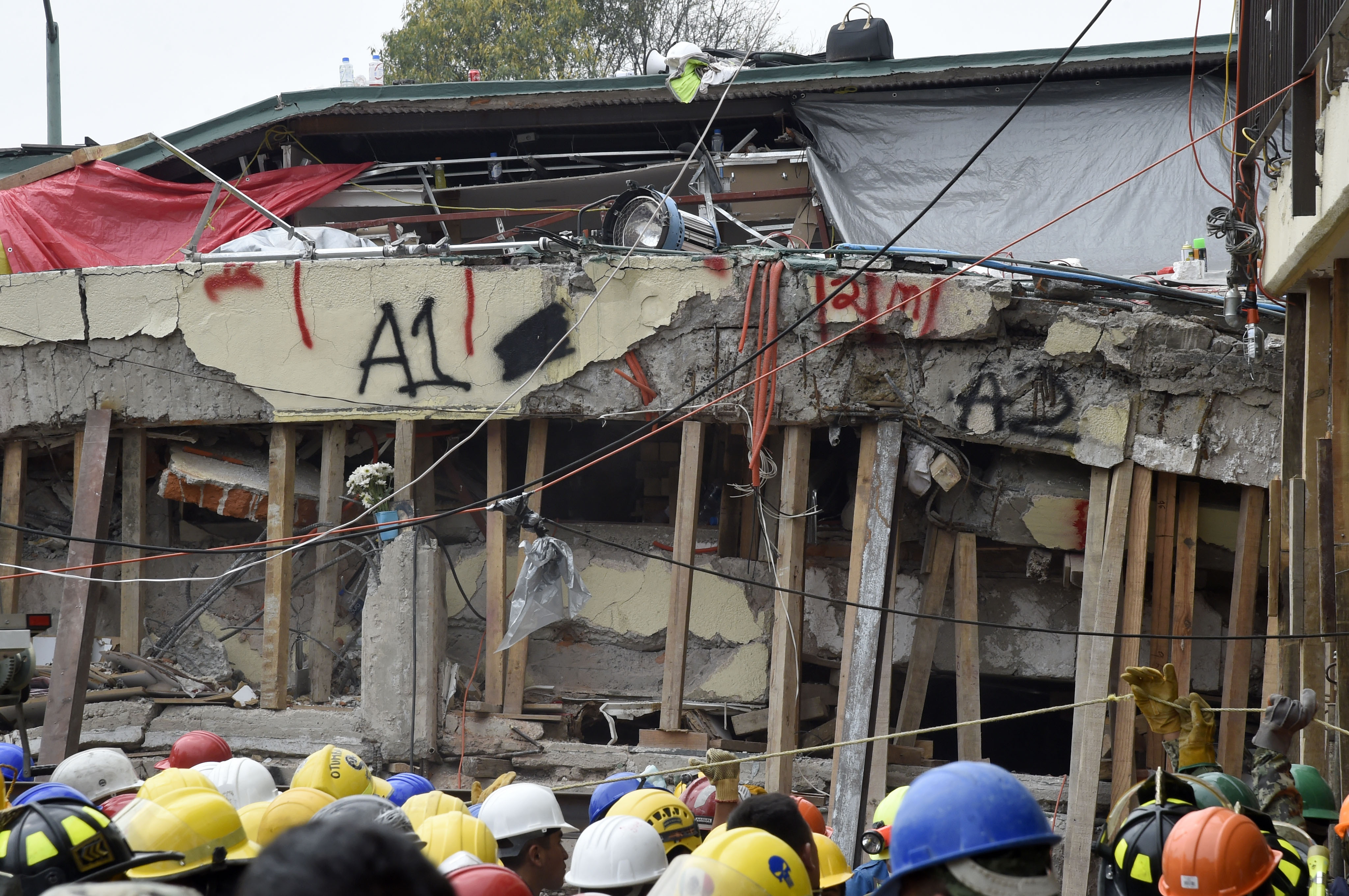 Rescue workers take part in the search for survivors and bodies at the Enrique Rebsamen elementary school in Mexico City on September 21, 2017, two days after a strong quake hit central Mexico. A powerful 7.1 earthquake shook Mexico City on Tuesday, causing panic among the megalopolis' 20 million inhabitants on the 32nd anniversary of a devastating 1985 quake. / AFP PHOTO / Alfredo ESTRELLA (Photo credit should read ALFREDO ESTRELLA/AFP/Getty Images)